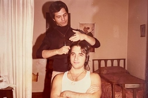 Eli giving a haircut in a bedroom, no barbershop required